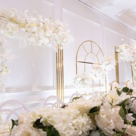 Golden luxury decor with elegant floral arrangement on the table, styled by Makkah Decorators in Melbourne.